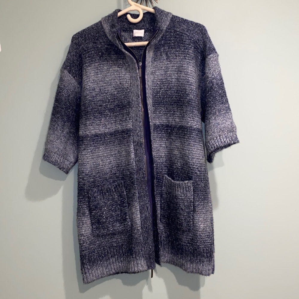 Long wool zip up jacket with quarter long sleeves.